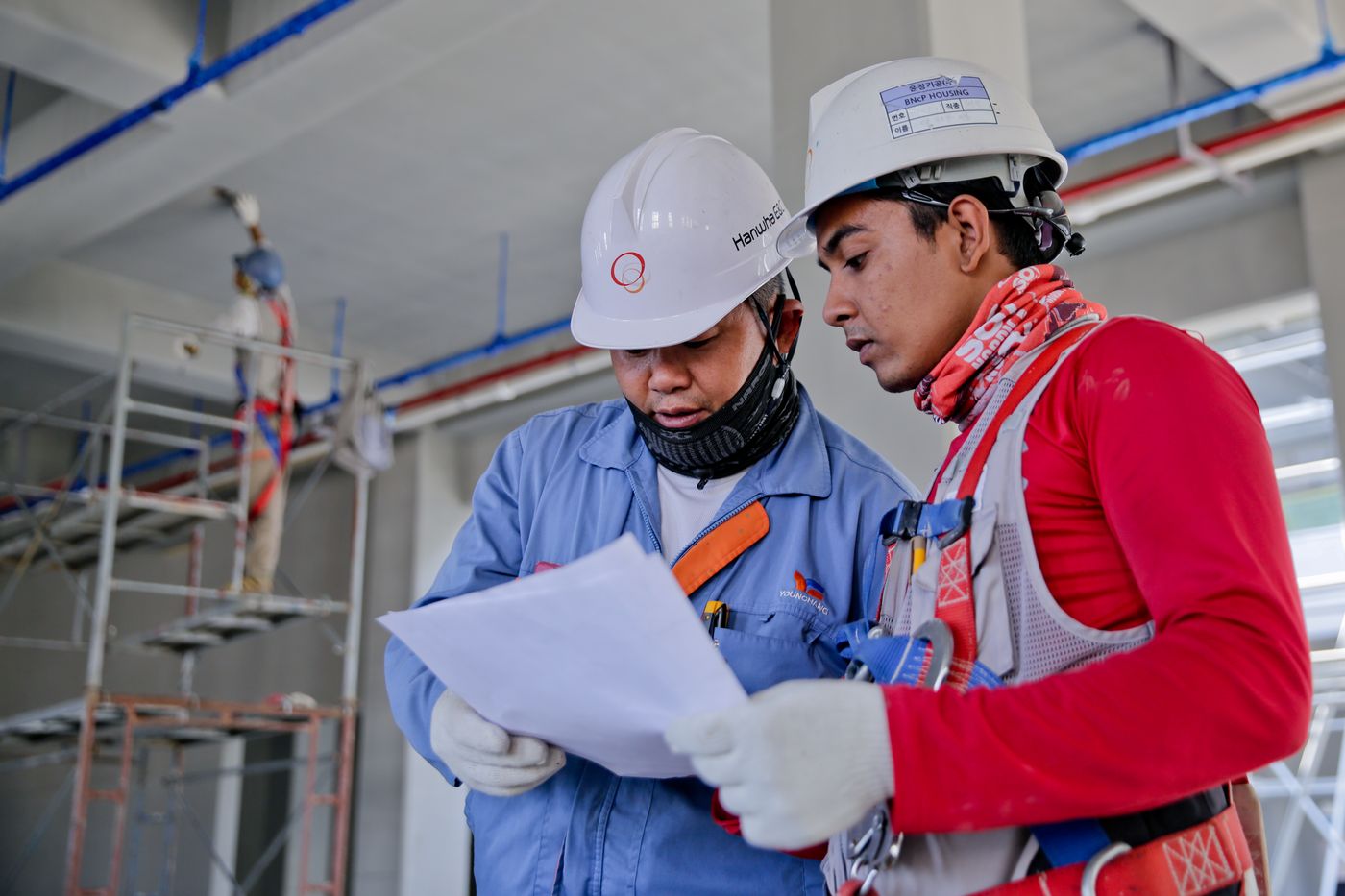 Two engineers discussing work at an industrial site